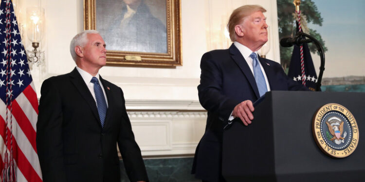 U.S. President Donald Trump speaks about the shootings in El Paso and Dayton as Vice President Mike Pence looks on in the Diplomatic Room of the White House in Washington, U.S., August 5, 2019. REUTERS/Leah Millis