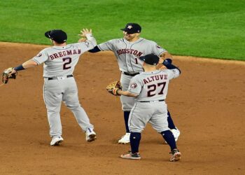 NEW YORK, NEW YORK - OCTOBER 15: Alex Bregman #2, Carlos Correa #1 and Jose Altuve #27 of the Houston Astros celebrate their 4-1 win over the New York Yankees during game three of the American League Championship Series at Yankee Stadium on October 15, 2019 in the Bronx borough of New York City.   Emilee Chinn/Getty Images/AFP