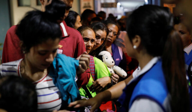 Venezuelan migrants queue at the Ecuadorian-Peruvian border service center, to process their documents and be able to continue their journey, on the outskirts of Tumbes, Peru June 14, 2019. Picture taken June 14, 2019. REUTERS/Carlos Garcia Rawlins