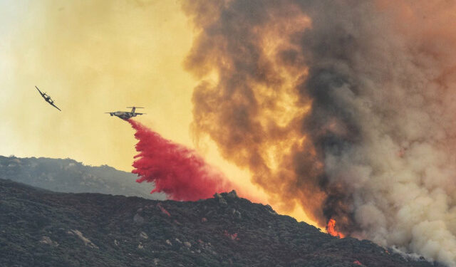 A plane drops fire retardant on a wildfire dubbed the Cave Fire at East Camino Cielo, California, U.S. November 26, 2019 in this picture obtained from social media.  Mike Eliason/Santa Barbara County Fire/via REUTERS  ATTENTION EDITORS -  THIS IMAGE HAS BEEN SUPPLIED BY A THIRD PARTY. MANDATORY CREDIT.