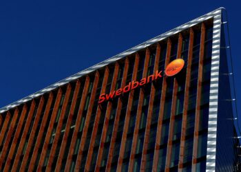 Swedbank sign is seen on the building of the bank's Lithuanian headquarters in Vilnius, Lithuania March 30, 2019. REUTERS/Ints Kalnins