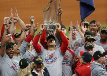 Oct 30, 2019; Houston, TX, USA; Washington Nationals left fielder Juan Soto hoists the Commissioners Trophy after defeating the Houston Astros in game seven of the 2019 World Series at Minute Maid Park. The Washington Nationals won the World Series winning four games to three. Mandatory Credit: Thomas B. Shea-USA TODAY Sports