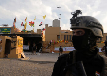 Members of Iraqi security forces are seen in front of U.S. Embassy during a protest to condemn air strikes on bases belonging to Hashd al-Shaabi (paramilitary forces), in Baghdad, Iraq January 1, 2020. REUTERS/Khalid al-Mousily