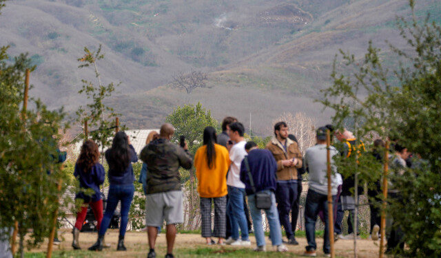 Spectators gather near the scene of a helicopter crash that reportedly killed retired basketball star Kobe Bryant in Calabasas, California, U.S., January 26, 2020.  REUTERS/Kyle Grillot