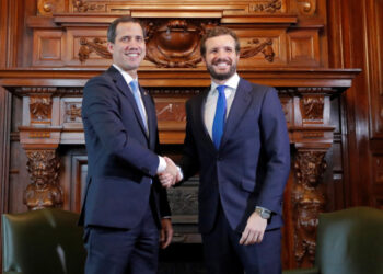 Venezuela's opposition leader Juan Guaido, who many nations have recognised as the country's rightful interim ruler, shakes hands with Pablo Casado, leader of Spain's People's Party (PP), during a meeting at Casa de America in Madrid, Spain, January 25, 2020. REUTERS/Susana Vera