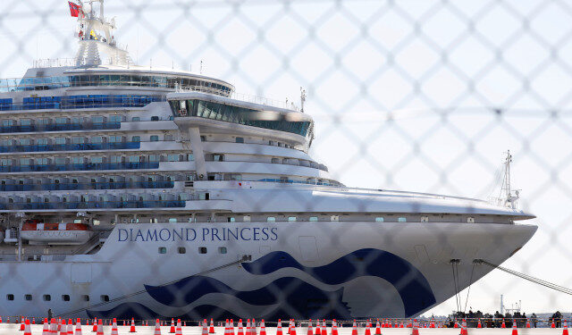 The cruise ship Diamond Princess, where dozens of passengers were tested positive for coronavirus, is seen through steel fence at Daikoku Pier Cruise Terminal in Yokohama, south of Tokyo, Japan, February 11, 2020. REUTERS/Issei Kato