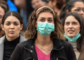 Tourist wearing protective respiratory masks wait on St. Peter's Square prior to the Pope's weekly Angelus prayer on February 2, 2020 in the Vatican. - A virus similar to the SARS pathogen has killed more than 300 people in China and spread around the world since emerging in a market in the central Chinese city of Wuhan. On February 2, China's National Health Commission said more than 14,000 people have been infected by the novel coronavirus. (Photo by Andreas SOLARO / AFP) (Photo by ANDREAS SOLARO/AFP via Getty Images)