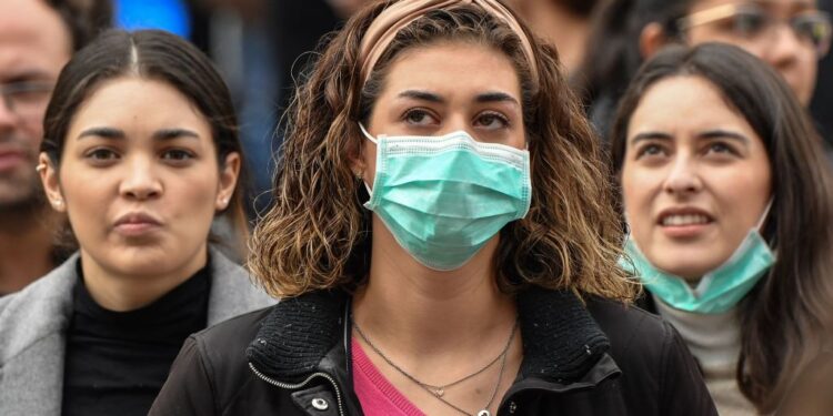 Tourist wearing protective respiratory masks wait on St. Peter's Square prior to the Pope's weekly Angelus prayer on February 2, 2020 in the Vatican. - A virus similar to the SARS pathogen has killed more than 300 people in China and spread around the world since emerging in a market in the central Chinese city of Wuhan. On February 2, China's National Health Commission said more than 14,000 people have been infected by the novel coronavirus. (Photo by Andreas SOLARO / AFP) (Photo by ANDREAS SOLARO/AFP via Getty Images)