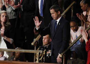 Venezuelan opposition leader Juan Guaido (C) pumps his fist as he is acknowledged by US President Donald Trump during his the State of the Union address at the US Capitol in Washington, DC, on February 4, 2020. (Photo by MANDEL NGAN / AFP)