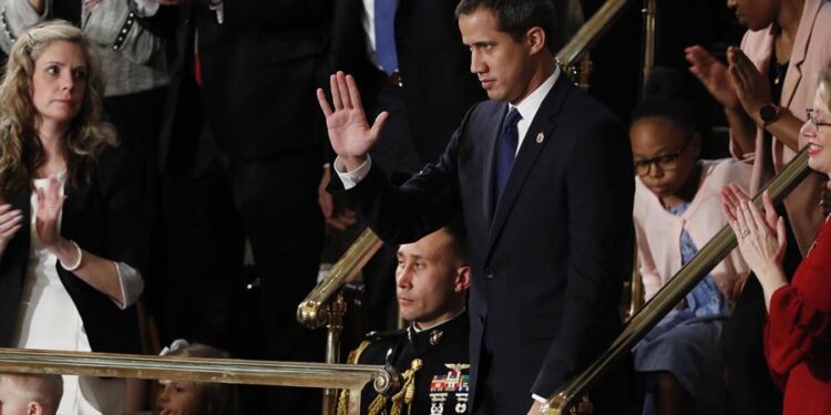 Venezuelan opposition leader Juan Guaido (C) pumps his fist as he is acknowledged by US President Donald Trump during his the State of the Union address at the US Capitol in Washington, DC, on February 4, 2020. (Photo by MANDEL NGAN / AFP)