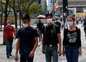 People wear protective masks in response to coronavirus (COVID-19) spread, in Caracas, Venezuela March 13, 2020. REUTERS/Carlos Jasso