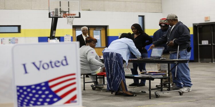 Voters check-in with poll workers at a polling station located at Mary Ford Elementary School during the primary election in North Charleston, South Carolina, on February 29, 2020. (Photo by Joshua Lott / AFP)