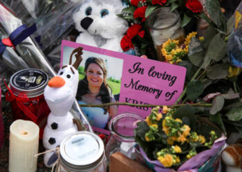 A photograph of Kristen Beaton, who was expecting her third child and was killed along Plains Road during Sunday’s mass shooting, is seen at a makeshift memorial in Debert, Nova Scotia, Canada April 23, 2020. REUTERS/Tim Krochak