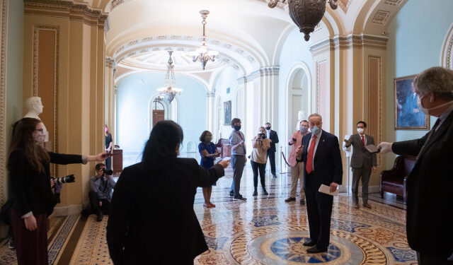 US Senate Minority Leader Chuck Schumer (R), Democrat of New York, wears a mask to protect himself and others from COVID-19, known as coronavirus, as he speaks to the press as the Senate returns into session at the US Capitol in Washington, DC, May 4, 2020. (Photo by SAUL LOEB / AFP)