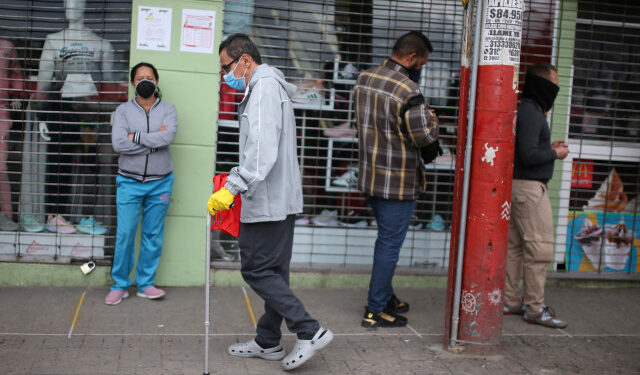 A man wearing a face mask walks down a street with a cane during the mandatory isolation decreed by the Colombian government as a preventive measure against the spread of the coronavirus disease (COVID-19) in Soacha, Colombia March 31, 2020. REUTERS/Luisa Gonzalez