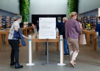 A customer uses a hand sanitizer dispenser at an Apple Inc. store reopening, after being closed due to lockdown measures imposed because of the coronavirus, in the Bondi Junction suburb of Sydney, Australia, on Thursday, May 7, 2020. Apple's app store saw its strongest month of growth in two and a half years in April, according to Morgan Stanley, which wrote that "all major regions & categories saw accelerating spend" as a result of the pandemic. Photographer: Brendon Thorne/Bloomberg