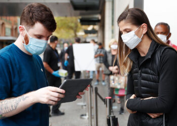 An employee assists a customer, both wearing protective masks, waiting in-line at an Apple Inc. store reopening, after being closed due to lockdown measures imposed because of the coronavirus, in the Bondi Junction suburb of Sydney, Australia, on Thursday, May 7, 2020. Apple's app store saw its strongest month of growth in two and a half years in April, according to Morgan Stanley, which wrote that "all major regions & categories saw accelerating spend" as a result of the pandemic. Photographer: Brendon Thorne/Bloomberg