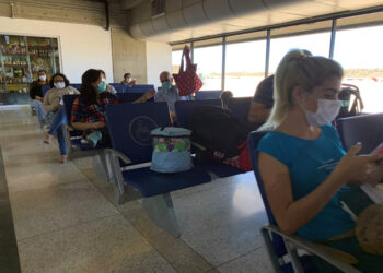 People wear protective masks in response to the spreading of coronavirus (COVID-19), at Simon Bolivar international airport in Maiquetia, Venezuela March 15, 2020. REUTERS/Carlos Jasso