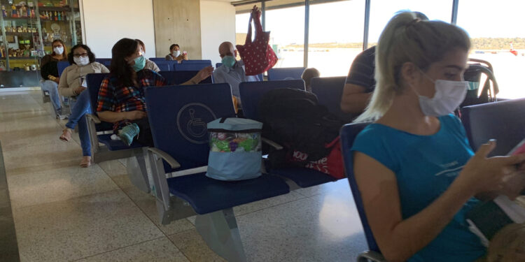 People wear protective masks in response to the spreading of coronavirus (COVID-19), at Simon Bolivar international airport in Maiquetia, Venezuela March 15, 2020. REUTERS/Carlos Jasso