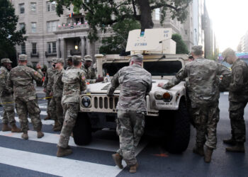 (FILES) In this file photo taken on June 7, 2020 members of the US National Guard stand near the White House as people protest against racism and police brutality in Washington, DC. - Members of the Washington DC national guard have tested positive for coronavirus in the wake of their deployment during recent protests in the US capital, the guard said on June 9, 2020. (Photo by Olivier DOULIERY / AFP)