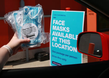 Masks are handed out at an A&W drive-through in Calgary on Wednesday, June 10, 2020.  Gavin Young/Postmedia