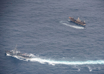 Ecuadorian Navy vessels surround a fishing boat after detecting a fishing fleet of mostly Chinese-flagged ships in an international corridor that borders the Galapagos Islands' exclusive economic zone, in the Pacific Ocean, August 7, 2020. Picture taken August 7, 2020.  REUTERS/Santiago Arcos