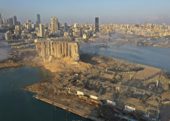 A drone picture shows the scene of an explosion that hit the seaport of Beirut, Lebanon, Wednesday, Aug. 5, 2020. A massive explosion rocked Beirut on Tuesday, flattening much of the city's port, damaging buildings across the capital and sending a giant mushroom cloud into the sky. (AP Photo/Hussein Malla)