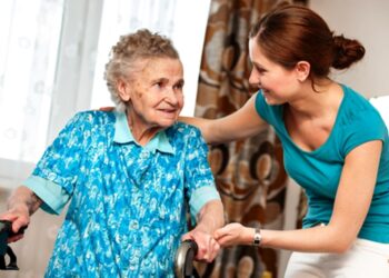 Senior woman with her caregiver at home