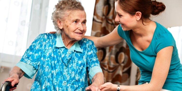 Senior woman with her caregiver at home