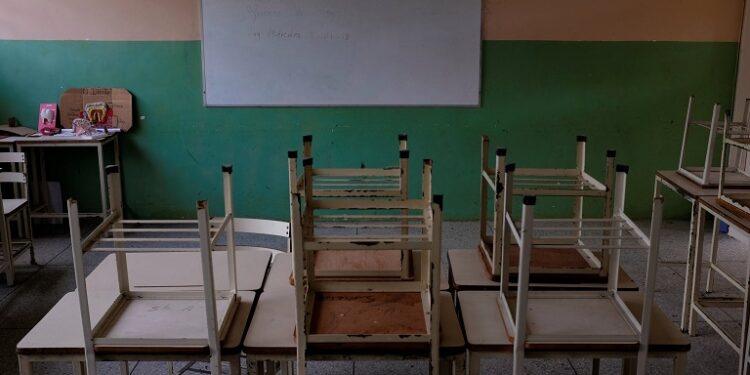 Empty desks are seen in the classroom on the first day of school, in Caucagua, Venezuela September 17, 2018. REUTERS/Marco Bello