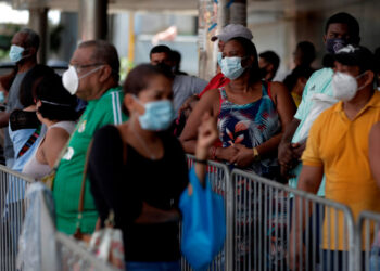 Personas hacen fila para entrar a un supermercado en San Miguelito este lunes en la ciudad de Panamá (Panamá). EFE/Bienvenido Velasco