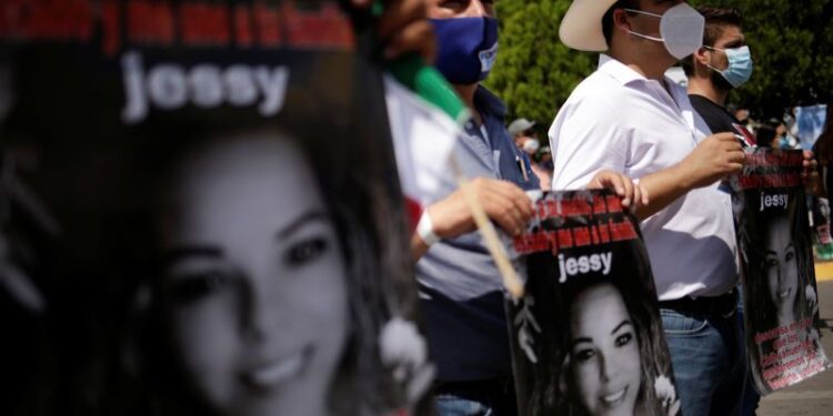 People hold placards as they attend a protest against the decision of the Mexican government to divert water from La Boquilla dam to the U.S., as part of a 1944 bilateral water treaty between the two countries, in Delicias, Chihuahua state, Mexico September 20, 2020. REUTERS/Jose Luis Gonzalez