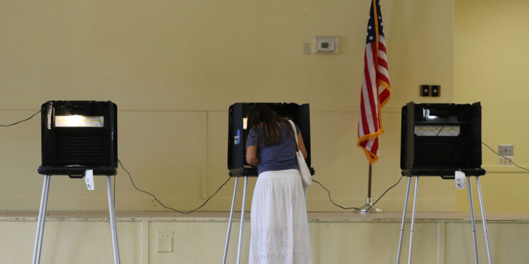 MIAMI, FLORIDA - NOVEMBER 03: Gissele Riberiro fills out her ballot as she votes at the Legion Park polling place on November 03, 2020 in Miami, Florida.  After a record-breaking early voting turnout, Americans head to the polls on the last day to cast their vote for incumbent U.S. President Donald Trump or Democratic nominee Joe Biden in the 2020 presidential election. (Photo by Joe Raedle/Getty Images)