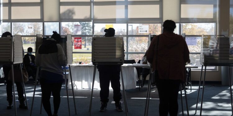 Voters cast ballots at a polling location for the 2020 Presidential election in Detroit, Michigan, U.S., on Tuesday, Nov. 3, 2020. American voters, at least those who've not yet cast ballots, go to the polls Tuesday to choose between President Donald Trump and Democratic nominee Joe Biden and cast votes in U.S. House and Senate races and state and local elections. Photographer: Emily Elconin/Bloomberg via Getty Images