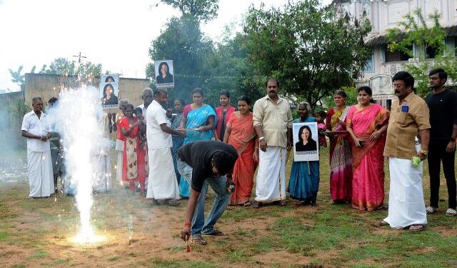 A man lights fireworks as villagers gather to celebrate the victory of U.S. Vice President-elect Kamala Harris in Painganadu near the village of Thulasendrapuram, where Harris' maternal grandfather was born and grew up, in the southern state of Tamil Nadu, India, November 8, 2020. REUTERS/Stringer NO ARCHIVES. NO RESALES.