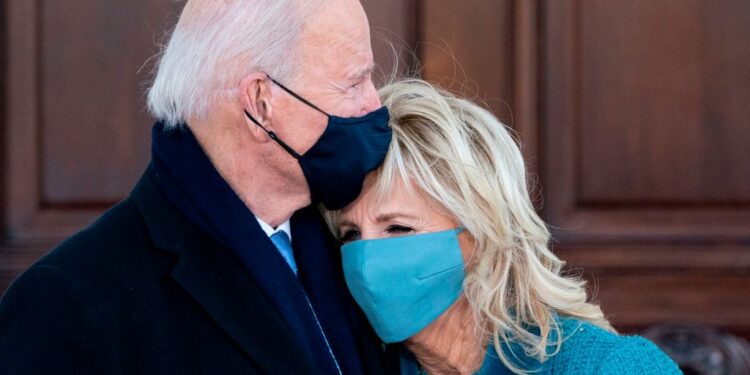 US President Joe Biden (L) hugs First Lady Jill Biden as they arrive at the White House in Washington, DC, on January 20, 2021. (Photo by Alex Brandon / POOL / AFP) (Photo by ALEX BRANDON/POOL/AFP via Getty Images)