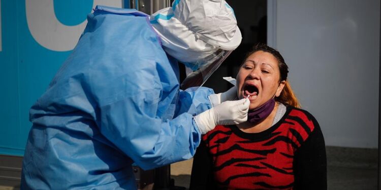 Un trabajador de la salud le practica una prueba para covid-19 a una mujer en la ciudad Villa Fiorito en la provincia de Buenos Aires (Argentina). EFE/Juan Ignacio Roncoroni/Archivo