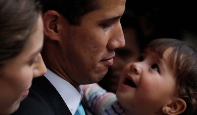 Venezuelan opposition leader and self-proclaimed interim president Juan Guaido pauses as he speaks to the media next to his wife Fabiana Rosales, while carrying their daughter outside their home after a meeting with supporters to present a government plan of the opposition in Caracas, Venezuela January 31, 2019. REUTERS/Carlos Barria