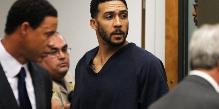 Former NFL football player Kellen Winslow Jr., center, leaves his arraignment Friday, June 15, 2018, in Vista, Calif. The former tight end was arrested Thursday on charges of rape and other sex crimes, the day he was to appear in court on an unrelated burglary charge. (Hayne Palmour/San Diego Union-Tribune via AP, Pool)