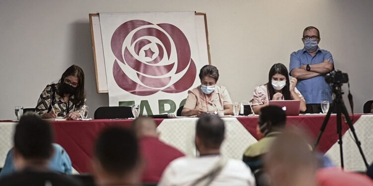 Rodrigo Londono aka "Timochenko" (R) is seen during the Second Extraordinary National Assembly of the Former FARC Political Party, in Medellin, Colombia on January 24, 2021. - During this assembly the former guerrillas decided to change the name of their political party from FARC to "Comunes" Commons. (Photo by JOAQUIN SARMIENTO / AFP)