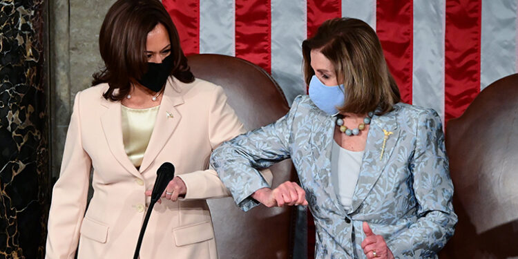 WASHINGTON, DC - APRIL 28: U.S. Vice President Kamala Harris (L) greets Speaker of the United States House of Representatives Nancy Pelosi (D-CA) ahead of U.S. President Joe Biden addressing a joint session of Congress in the House chamber of the U.S. Capitol April 28, 2021 in Washington, DC. On the eve of his 100th day in office, Biden will speak about his plan to revive America's economy and health as it continues to recover from a devastating pandemic. He will deliver his speech before 200 invited lawmakers and other government officials instead of the normal 1600 guests because of the ongoing COVID-19 pandemic. (Photo by Jim Watson - Pool/Getty Images)