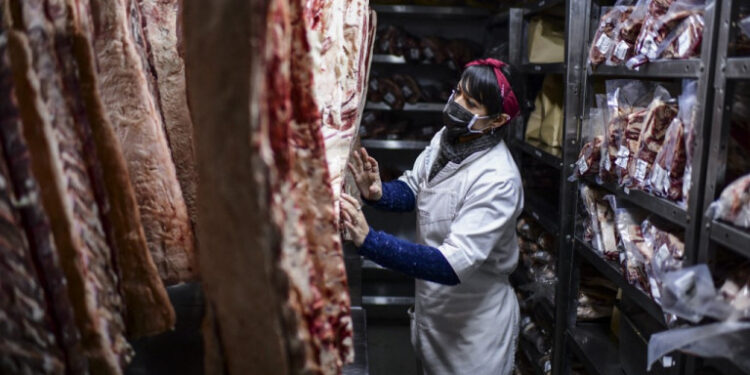 A butcher works at the butcher's shop of the Don Julio restaurant in Palermo neighbourhood, Buenos Aires, on 20 May 2021. - Argentina, recognized worldwide as a producer of excellent meat, is the world's fourth largest exporter of this product whose international price is on the rise. But although the country benefits from foreign exchange earnings (3,368 million dollars in 2020), the cost in the domestic market has shot up 65% in the midst of an accelerated inflationary process. The government of center-left President Alberto Fernandez, suspended beef exports for 30 days, and cattle producers, who reacted with a nine-day marketing stoppage. (Photo by RONALDO SCHEMIDT / AFP)