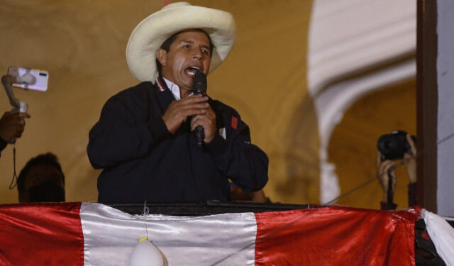 Peruvian leftist presidential candidate Pedro Castillo of Peru Libre talks to supporters from his party headquarters balcony in Lima on June 8, 2021, keeping a narrow lead in the final vote tally with right-wing candidate Keiko Fujimori on Fuerza Popular following the runoff election of June 6. - Peru was on edge Tuesday as right-wing populist Keiko Fujimori cried foul after far-left rival Pedro Castillo took a narrow lead in the final stretch of vote-counting to decide who will be the country's next president. (Photo by Gian MASKO / AFP)