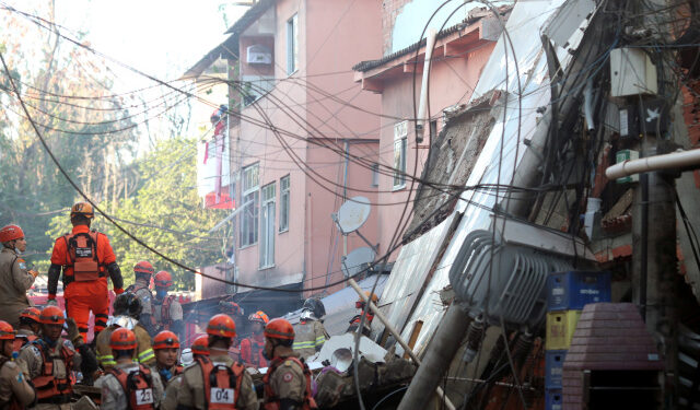 Firefighters search for victims between the debris of a collapsed building in Rio das Pedras slum, Rio de Janeiro, Brazil, June 3, 2021. REUTERS/Ricardo Moraes