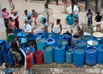 CARACAS, VENEZUELA - MAY 28: People fill water containers from a water truck in Petare on May 28, 2020 in Caracas, Venezuela.  NGO Human Rights Watch questioned figures released by the Maduro Government and issued an alert about the possible collapse of the spread of Coronavirus in Venezuela due to its health and humanitarian crisis. Venezuela has a severe water shortage worsening the health situation in the country. As of May 25, Venezuela has officially confirmed 1,121 positive cases of  COVID-19. (Photo by Carlos Becerra/Getty Images)