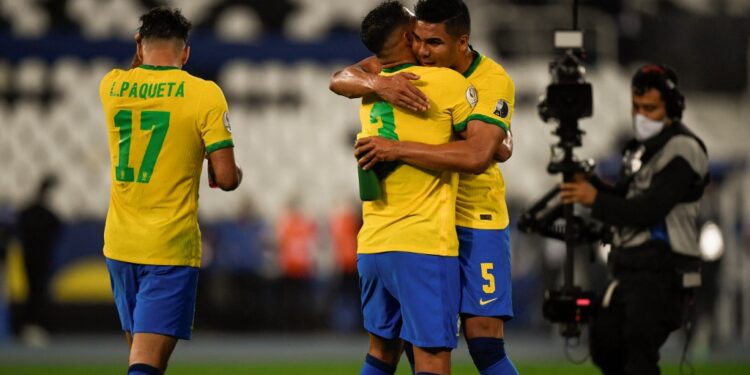 Brazil's Casemiro (R) and Brazil's Thiago Silva celebrate defeating Chile in their Conmebol 2021 Copa America football tournament quarter-final match at the Nilton Santos Stadium in Rio de Janeiro, Brazil, on July 2, 2021. (Photo by MAURO PIMENTEL / AFP)