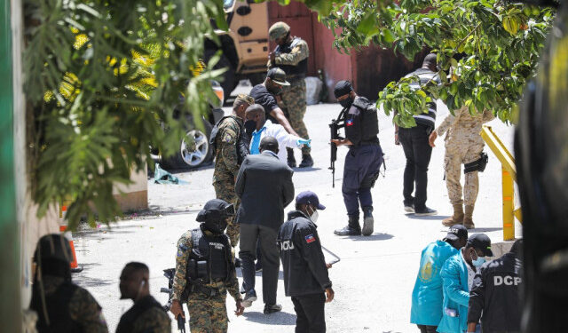 Members of the Haitian police and forensics look for evidence outside of the presidential residence on July 7, 2021 in Port-au-Prince, Haiti. - Haiti President Jovenel Moise was assassinated and his wife wounded early July 7, 2021 in an attack at their home, the interim prime minister announced, an act that risks further destabilizing the Caribbean nation beset by gang violence and political volatility. Claude Joseph said he was now in charge of the country and urged the public to remain calm, while insisting the police and army would ensure the population's safety.The capital Port-au-prince as quiet on Wednesday morning with no extra security forces on patrol, witnesses reported. (Photo by VALERIE BAERISWYL / AFP)