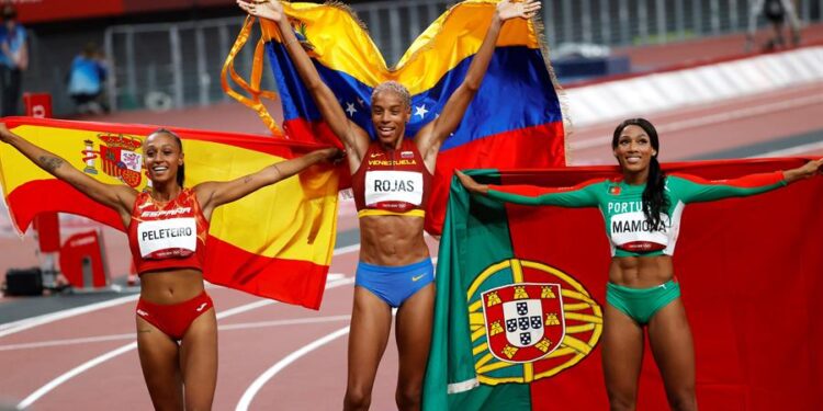 Gold medalist Yulimar Rojas (C) of Venezuela, Silver medalist Patricia Mamona (R) of Portugal and bronze medalist Ana Peleteiro (L) of Spain celebrate after the Women's triple jump final during the Athletics events of the Tokyo 2020 Olympic Games at the Olympic Stadium in Tokyo, Japan, 01 August 2021. (Triple salto, Japón, España, Tokio) EFE/EPA/HOW HWEE YOUNG