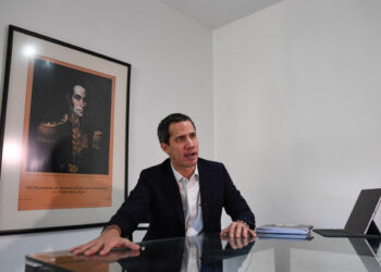 Venezuelan opposition leader Juan Guaido gestures as he speaks during an interview with the AFP at his home in Caracas on August 25, 2021. (Photo by Federico PARRA / AFP)