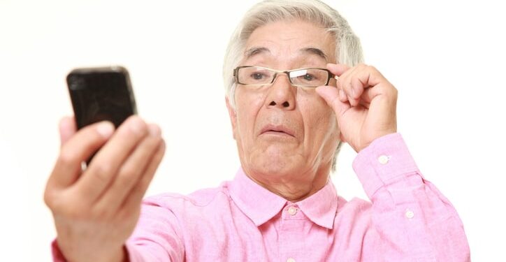 studio shot of senior Japanese man on white background